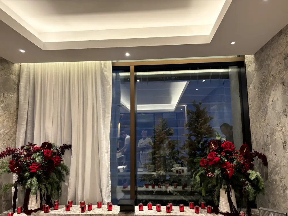 Pair of matching red arrangements either side of a floor to ceiling window