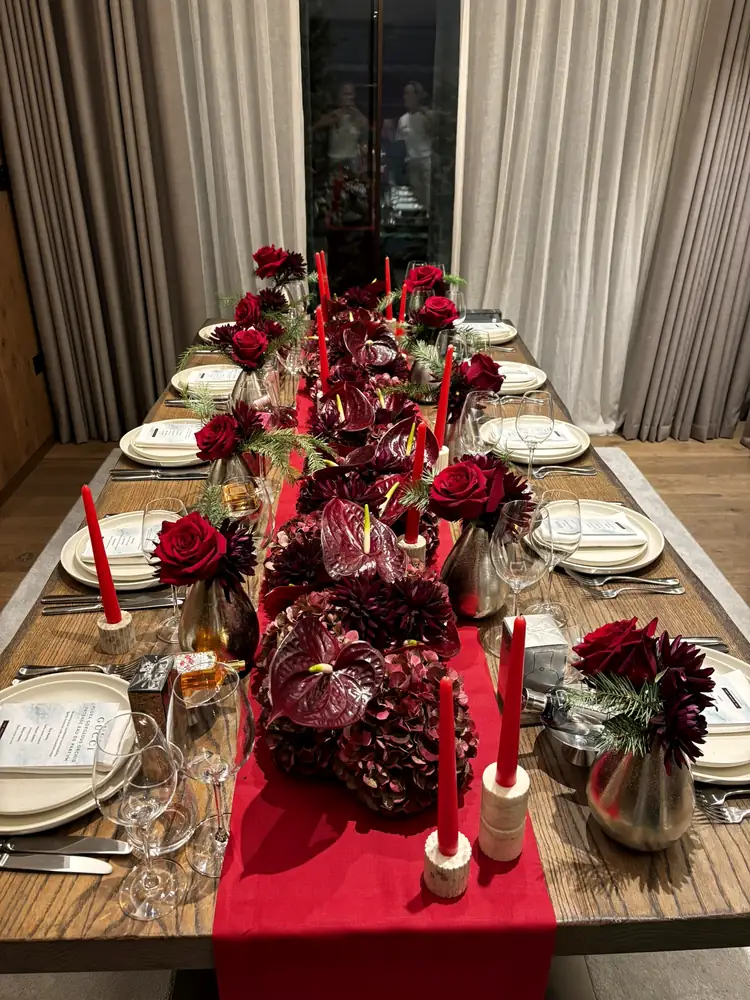 Long dining table styled in claret and red