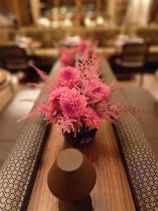 Pink arrangement on a long restaurant table