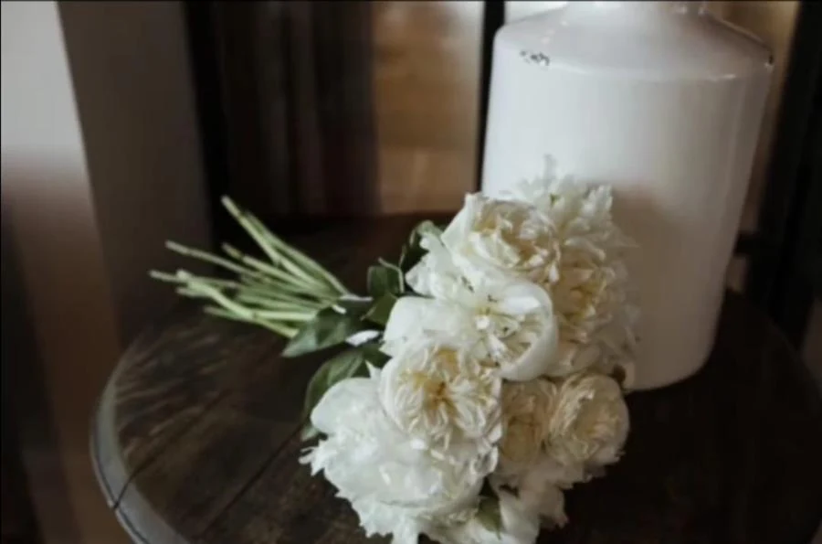 Hand tied bouquet of white peonies and garden roses